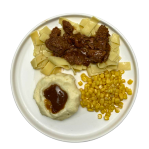 BEEF TIPS AND EGG NOODLES ON PLATE